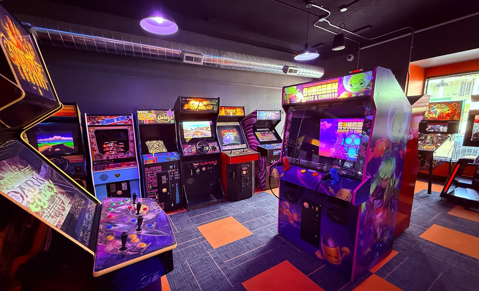 Classic arcade cabinets along the brick wall